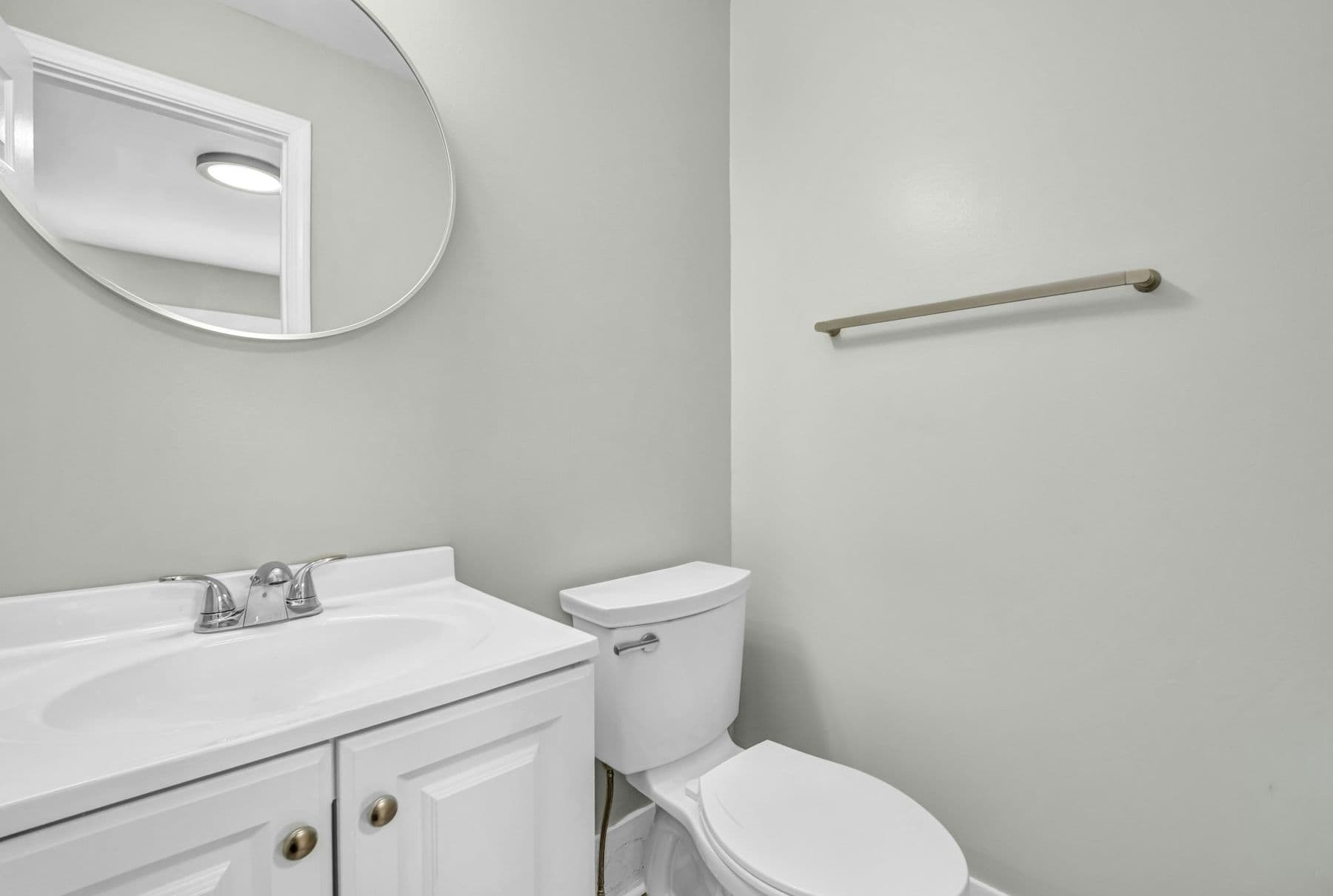 Small bathroom with a white vanity and toilet
